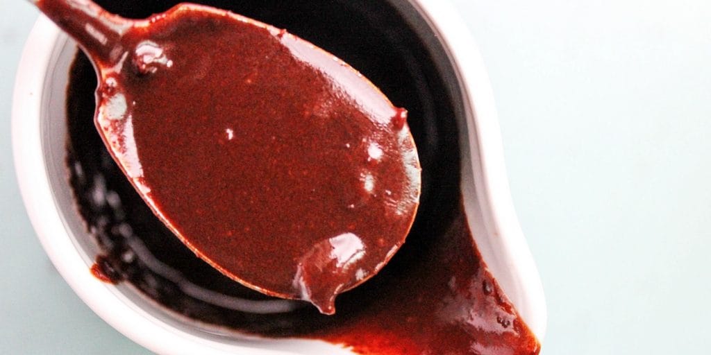 spoon of hot fudge sauce with bacon