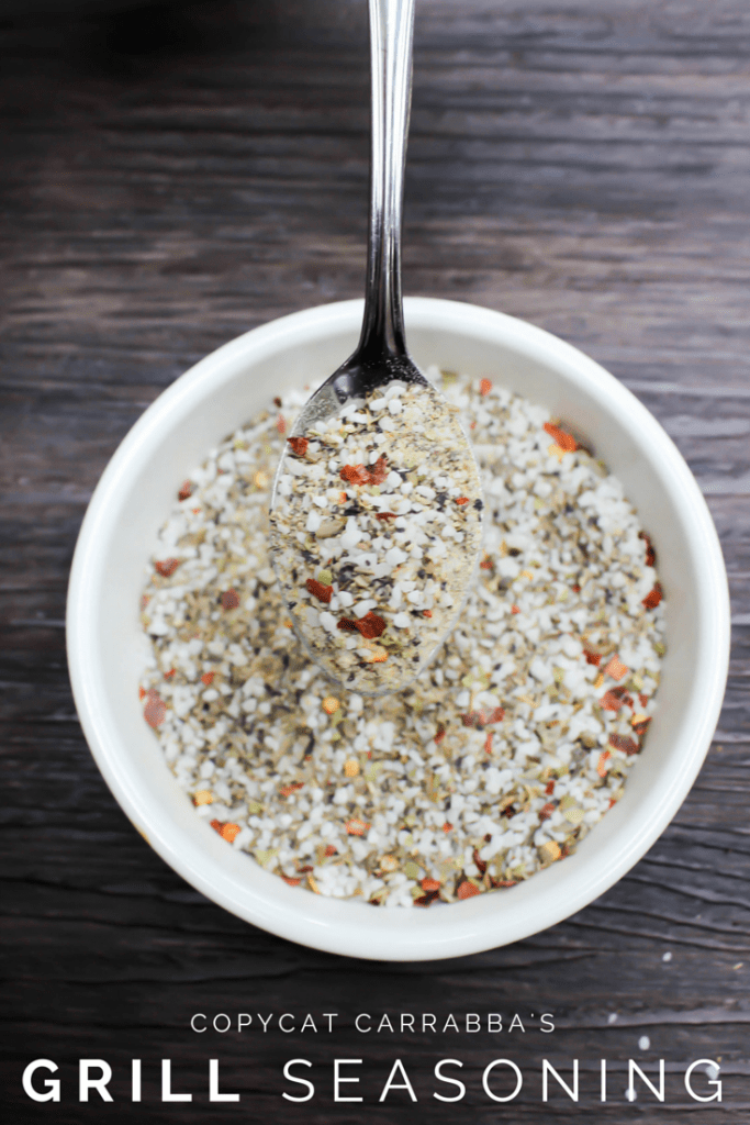 grill seasoning with a spoon in a white bowl