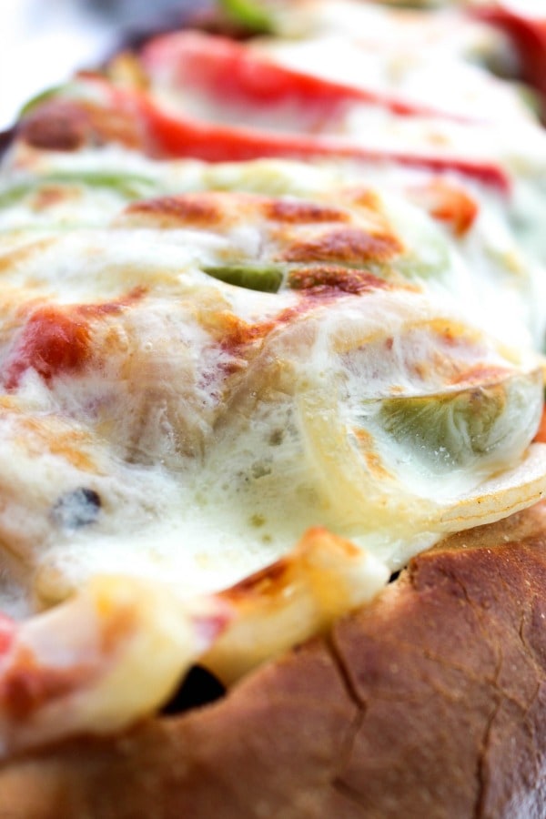 Cheesy Italian Sausage & Pepper Stuffed Bread is a twist the classic ball park sandwich, made into a fantastically easy meal. Cheesy Italian Sausage & Pepper Stuffed Bread is a twist the classic ball park sandwich, made into a fantastically easy meal. sausage-pepper-stuffed-bread-close-up