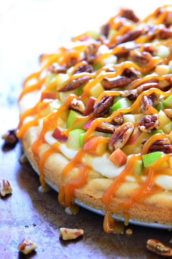 sugar cookie crust, cream cheese frosting, toasted pecans and a drizzle of caramel.