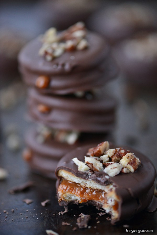 Turtle Ritz Cookies, Ritz crackers filled with homemade caramel dipped in chocolate almond bark, topped with pecans
