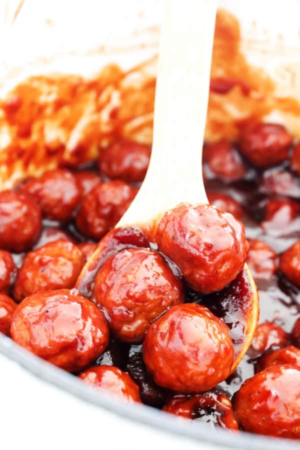 SWEET & TANGY BARBECUE MEATBALLS - Ready in 30-minutes and made with a few simple ingredients, they make appetizer or even as dinner a meatball subs. Sweet & Tangy Barbecue Meatballs in a pot with a wooden spoon