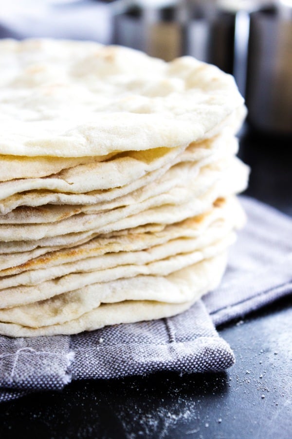 Best Ever Flour Tortillas are so easy & delicious that once you make these you'll never go back to store bought tortillas again. stack of finished Flour Tortillas
