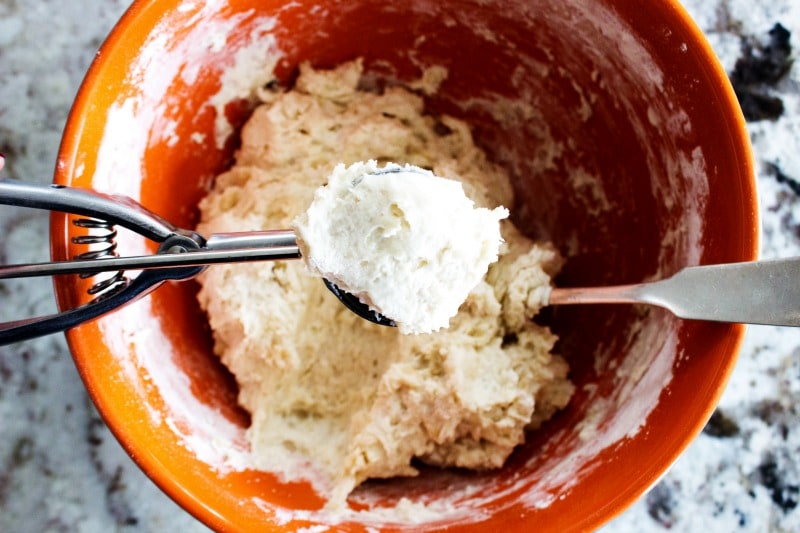 Best Ever Flour Tortillas are so easy & delicious that once you make these you'll never go back to store bought tortillas again. Flour Tortilla dough in a bowl with an up close cookie scoop full of dough