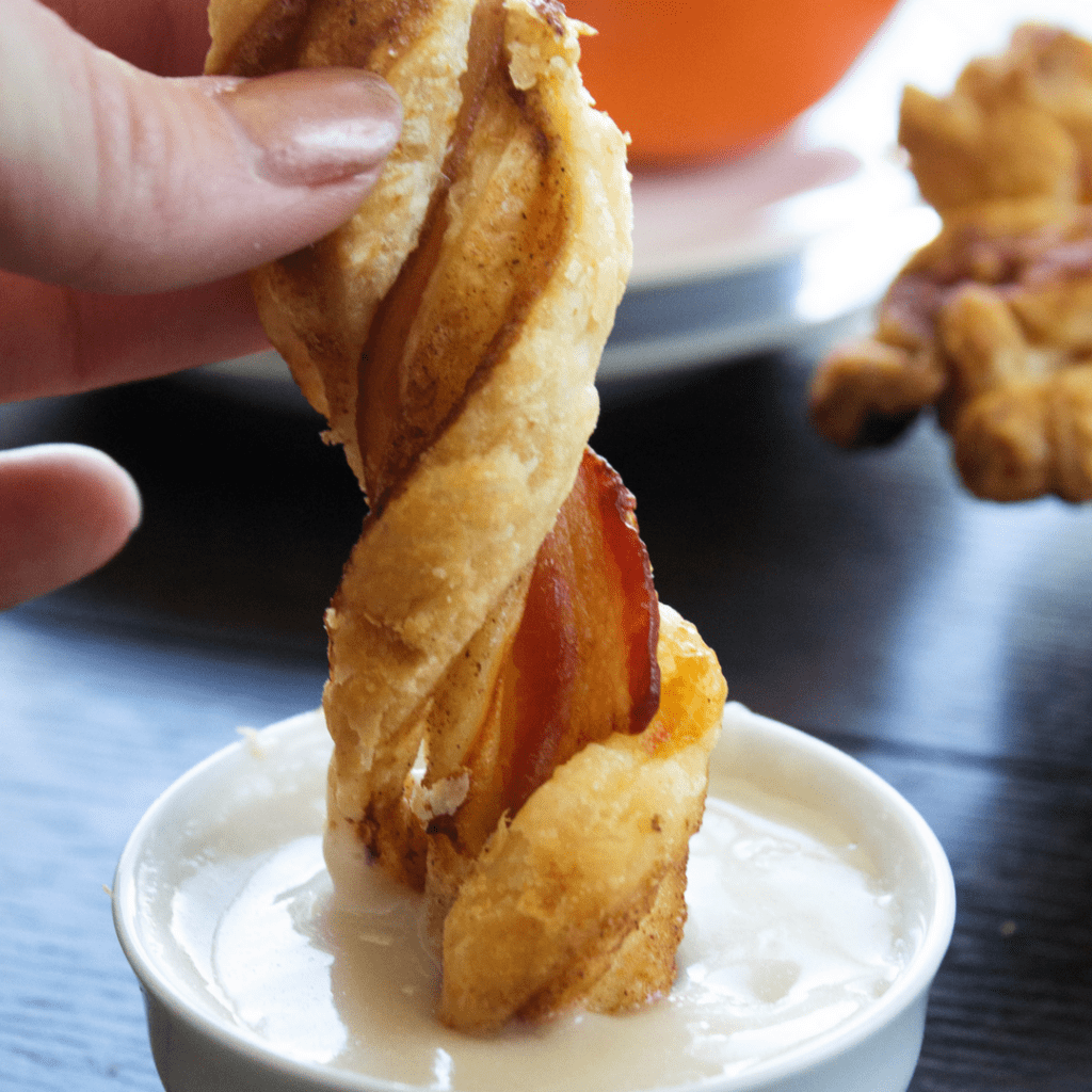 cinnamon bacon twist dipped into cream cheese frosting