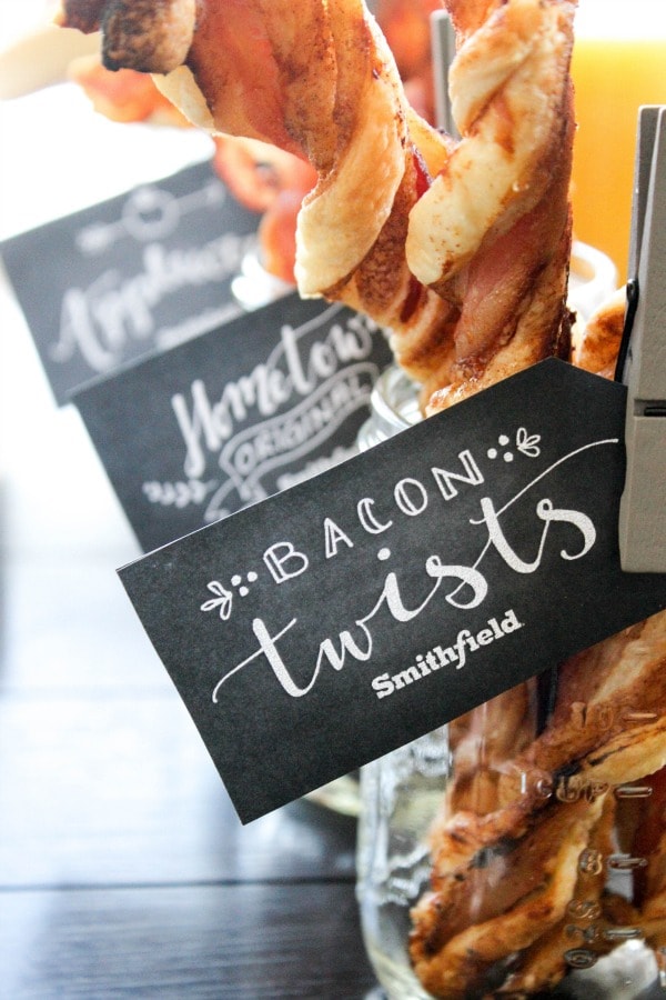 glass jars with Crispy Bacon Cinnamon Roll Twists in them, with tags on jars that say "bacon twists- smithfield