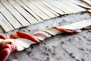 twisting bacon and pastry dough