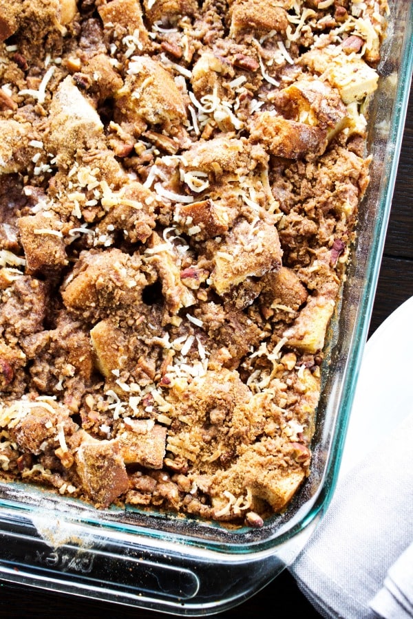 Overnight Coconut Cinnamon Pecan French Toast Casserole - Elevate your morning breakfast with this deliciously easy, make-ahead-breakfast casserole. photo of Overnight Coconut Cinnamon Pecan French Toast Casserole baked in a glass pan