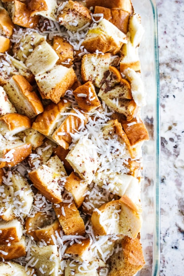 Overnight Coconut Cinnamon Pecan French Toast Casserole - Elevate your morning breakfast with this deliciously easy, make-ahead-breakfast casserole. photo of prepared Overnight Coconut Cinnamon Pecan French Toast Casserole in a glass pan, unbaked