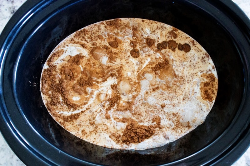 Slow Cooker Triple Chocolate Hot Cocoa is a rich, decadent hot cocoa made at the ease of your slow cooker. Chocolate lovers will be swooning over this one. overhead shot of hot chocolate in crock pot
