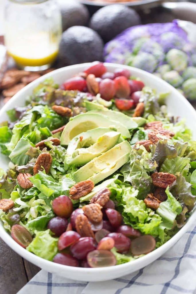 EASY HARVEST SALAD in a white bowl, salad with avocado, grapes, pecans