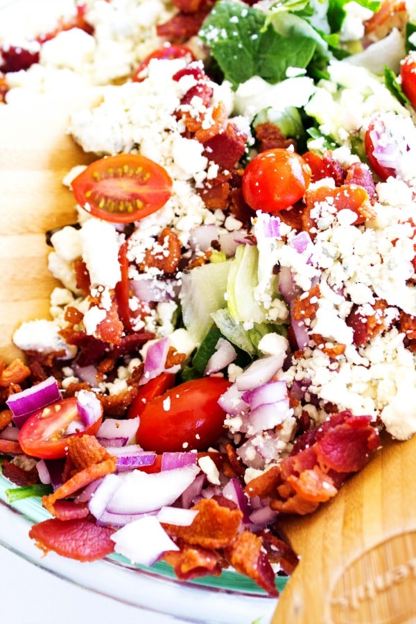 Chopped Wedge Salad is a simple green salad, fully loaded with bacon & blue cheese. Dress it up or down, either way the entire family will love this salad. Chopped Wedge Salad is a simple green salad, fully loaded with bacon & blue cheese. Dress it up or down, either way the entire family will love this salad.