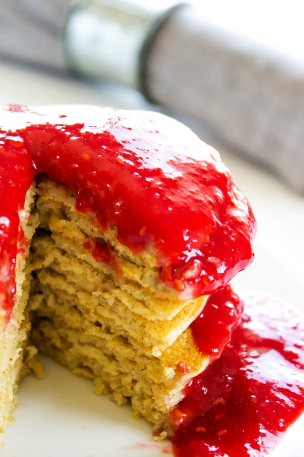 stack of pancakes with raspberry sauce