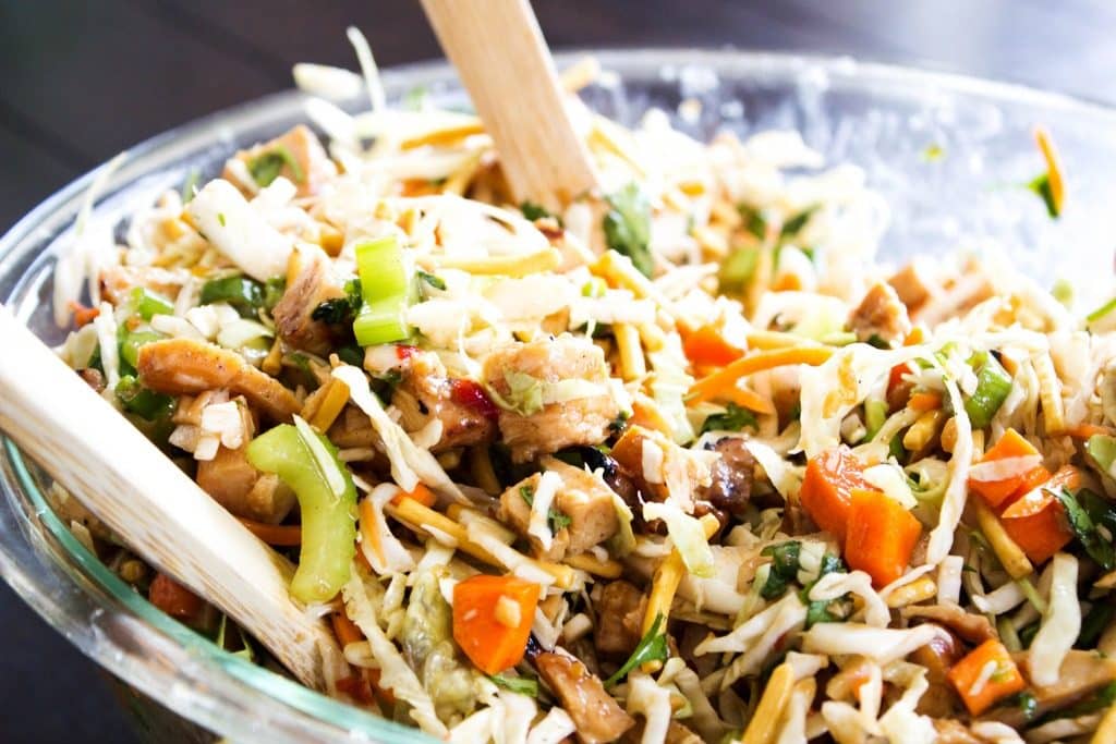 Asian salad in a bowl with two spoons