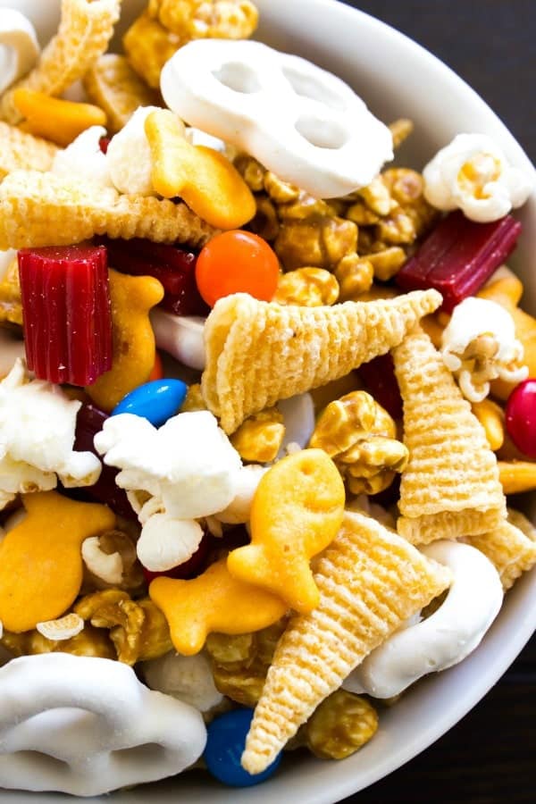 Chimney Park Trail Mix with goldfish, M&M's popcorn, yogurt covered pretzels, caramel corn, licorice and bugels in a white bowl