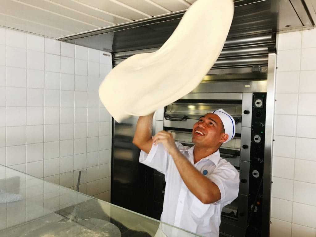 photo of chef on cruise tossing pizza dough.