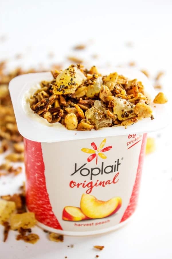 PINA COLADA GRANOLA - a tropical version of granola. Made with coconut, macadamia nuts and dried pineapple, this granola is a perfectly wholesome snack or breakfast. PINA COLADA GRANOLA - Yogurt on white table