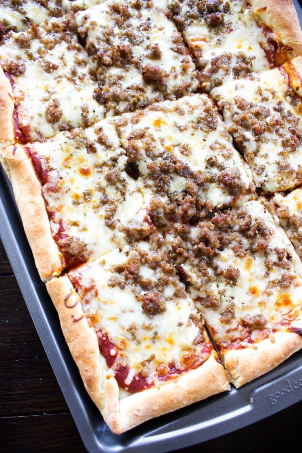 overhead view of sheet pan pizza with sausage topping.