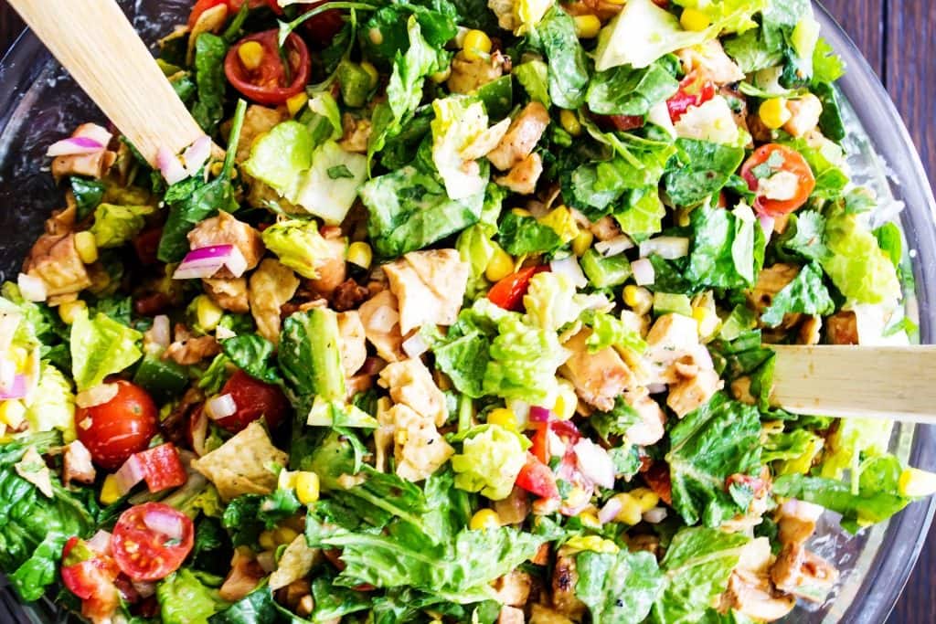 collage image green salad topped with barbecue chicken over head shot