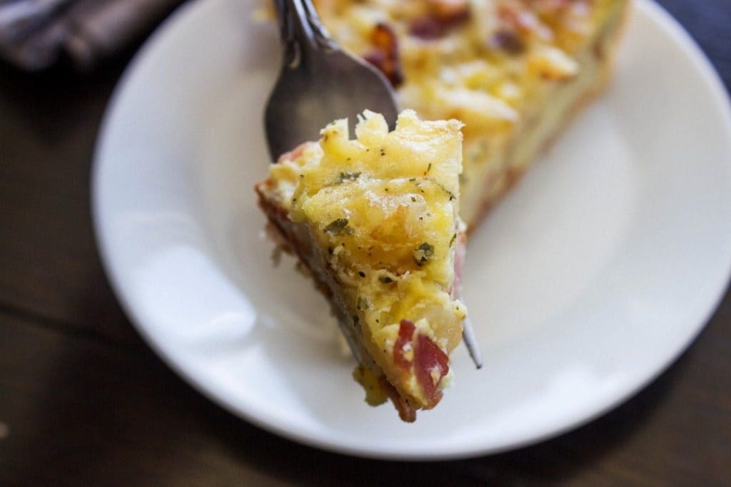 RANCH BACON POTATO QUICHE - White plate, metal fork, wooden table 