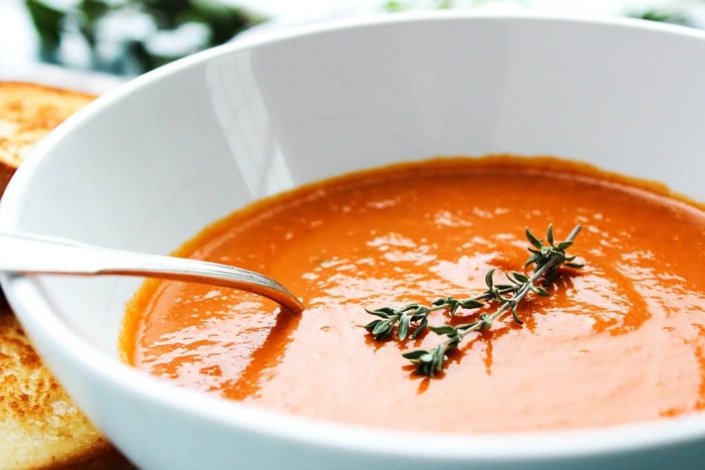 SLOW COOKER TOMATO SOUP - White bowl, metal spoon 