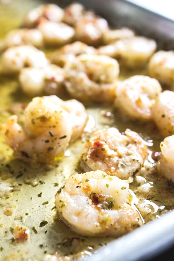 SHRIMP SCAMPI PASTA SALAD a classic summer dish with an added twist. With just a few simple ingredients, this pasta salad is elevated to a whole new level of deliciousness. SHRIMP SCAMPI PASTA SALAD cooked shrimp on baking sheet