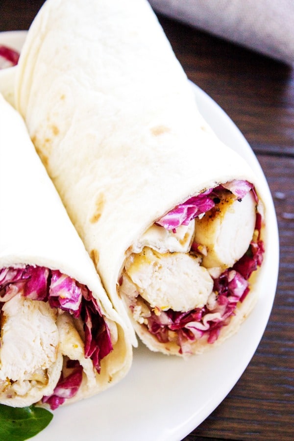 SIMPLE CITRUS CHICKEN WRAPS - White plate, wood table, grey napkin 