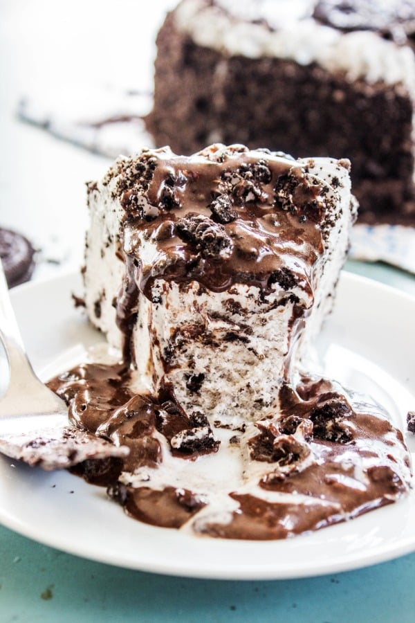 ice cream cake with oreo hot fudge sauce with bite taken out of it