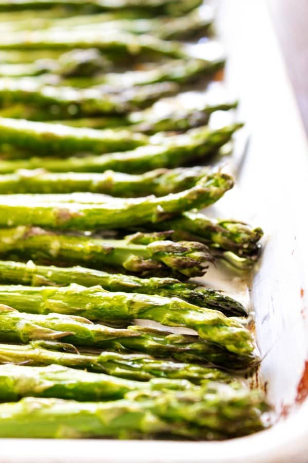 EASY OVEN ROASTED GARLIC ASPARAGUS - a simple & delicious way to prepare & cook asparagus in just under 20 minutes. Close-up shot of the cooked asparagus.