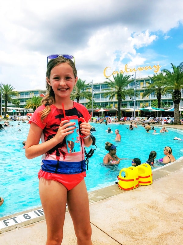 photo of girl in bathing suit at castaway resort pool holding refillable cup