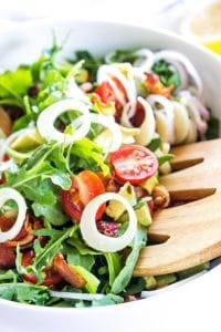 arugula salad in white bowl