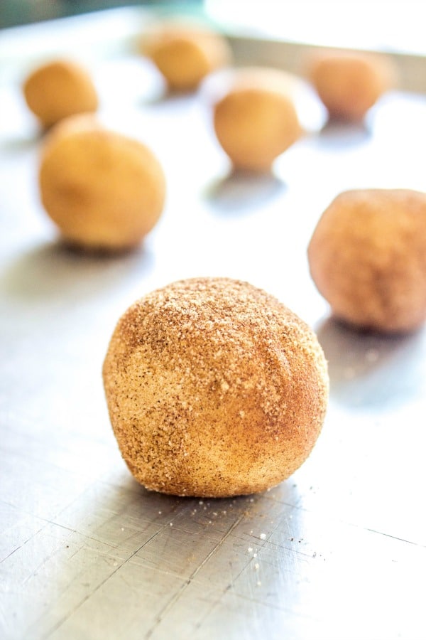 Cookie dough in balls on metal cookie sheet 