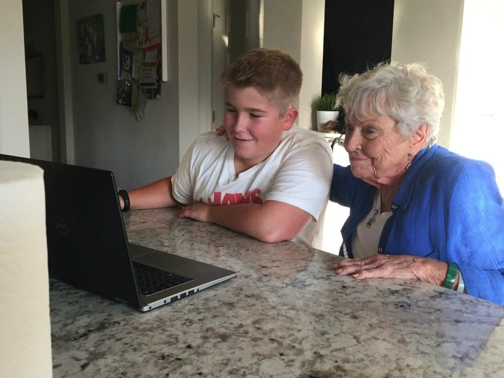 Son Aiden and Grandma GiGi looking over coin collection online 