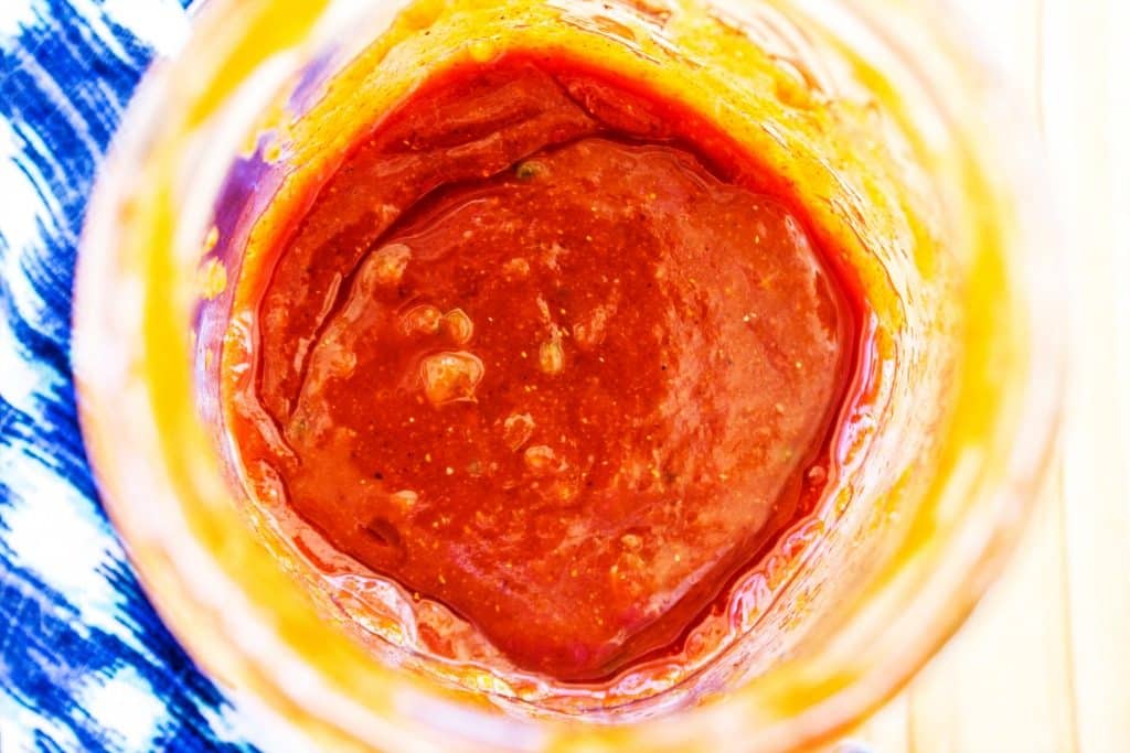Sauce in large mason jar, blue napkin.
