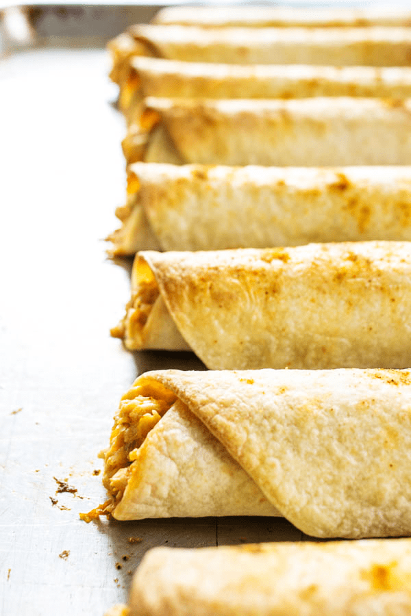 baked taquitos on baking sheet