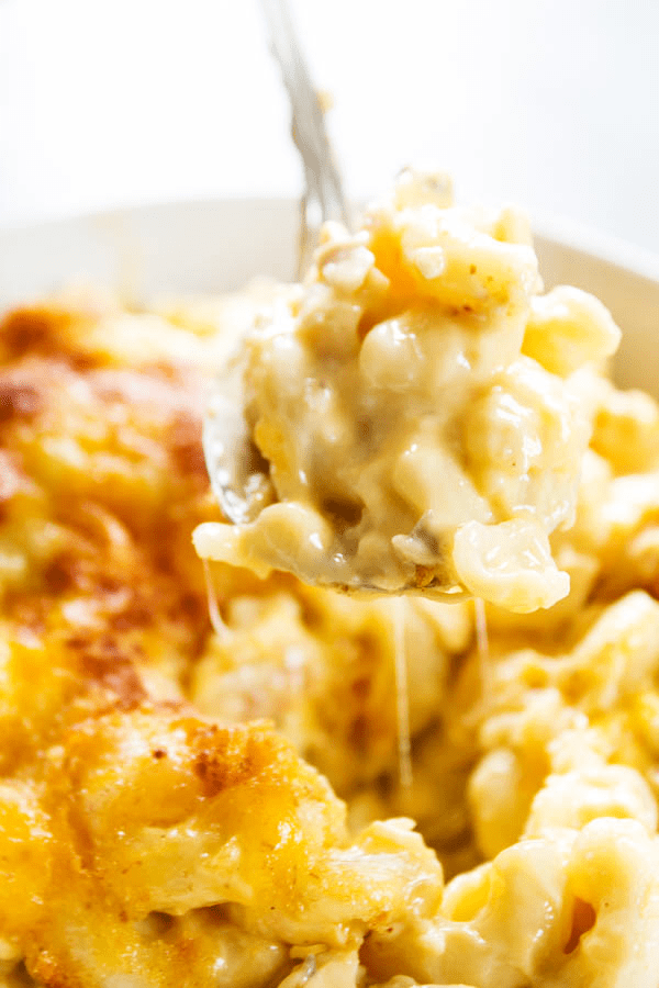 BEST EVER TUNA NOODLE CASSEROLE - creamy, cheesy and completely delicious, this casserole is even adored by those who say they hate Tuna Noodle Casserole. up close photo of a spoonful of TUNA NOODLE CASSEROLE being pulled from the dish