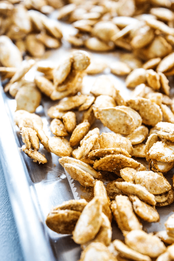 photo of cinnamon sugar pumpkin seeds on a sheet pan