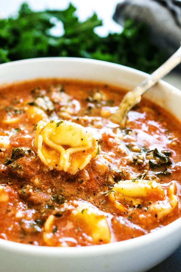 This hearty SLOW COOKER TUSCAN TORTELLINI SOUP will be a family favorite. Delicious & easy to make, you're simply going to love how easy it comes together. SLOW COOKER TUSCAN TORTELLINI SOUP spoon with tortellini