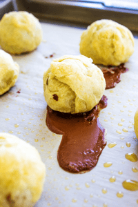 pains au chocolat on baking sheet with chocolate running out