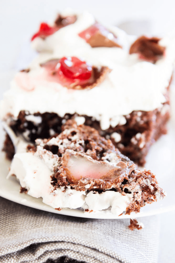 CHOCOLATE COVERED CHERRY POKE CAKE - A rich & gooey chocolate cake with chocolate covered cherries; spread some holiday cheer with this simple dessert.