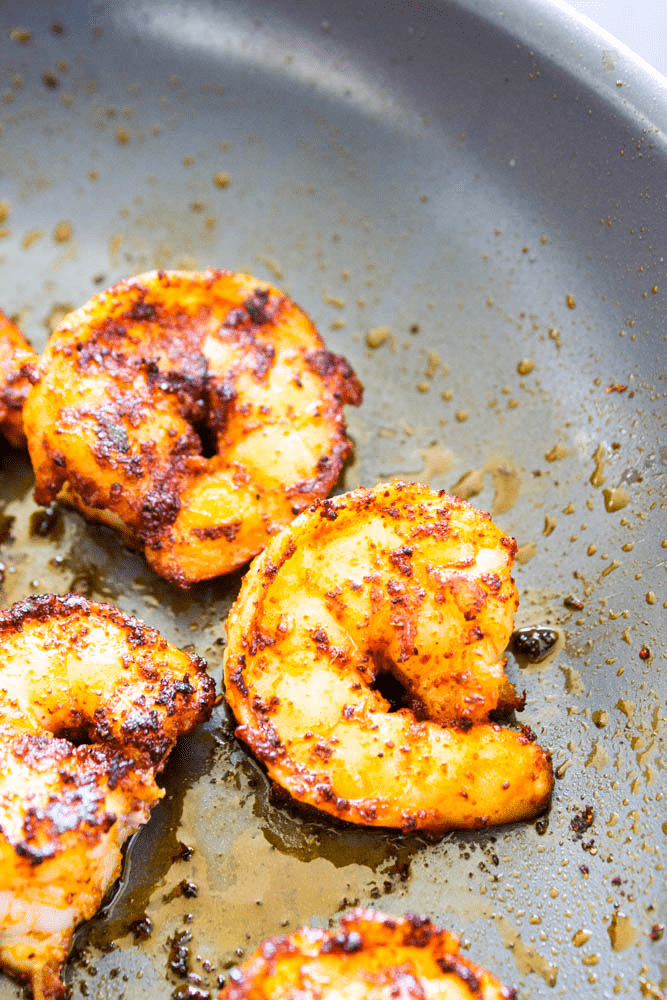 Simple, easy and insanely delicious, this recipe for CHILI RUBBED SHRIMP AND AVOCADO CROSTINI makes a great appetizer, snack or meal for busy nights. Chili rubbed shrimp cooking in skillet