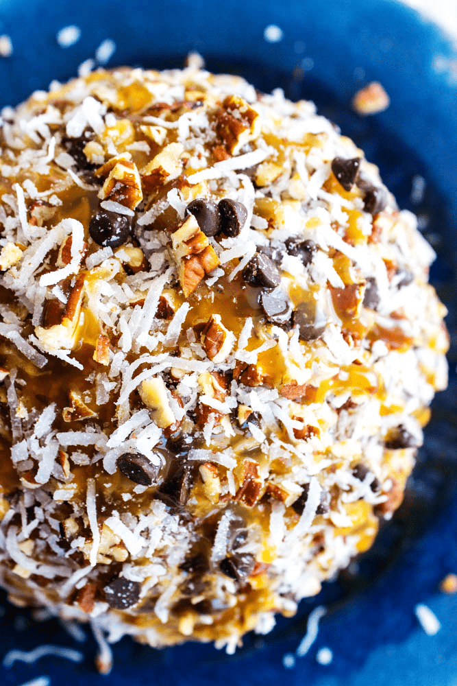 close up overhead German Chocolate Cheesecake Ball on a plate.