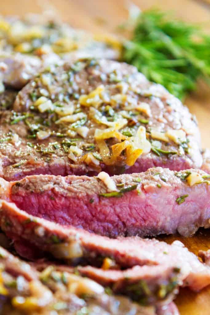 Pan-Seared Steak partly sliced on a cutting board
