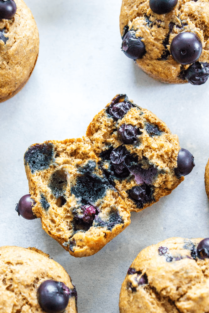 Banana Blueberry Muffins on counter with one split in half