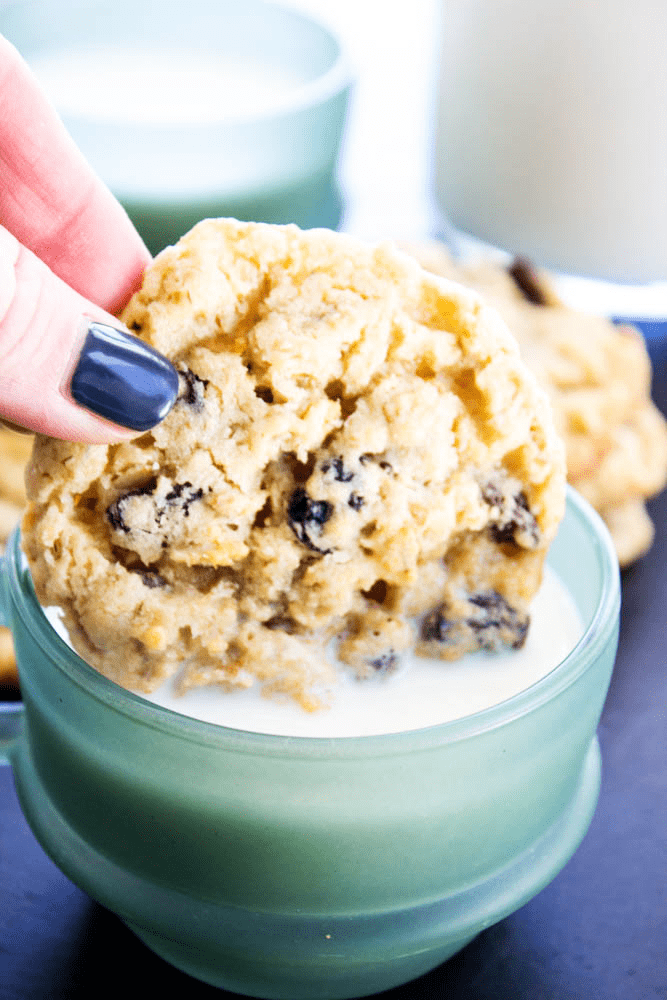 Oatmeal Raisin Cookie being dipped into a glass of milk