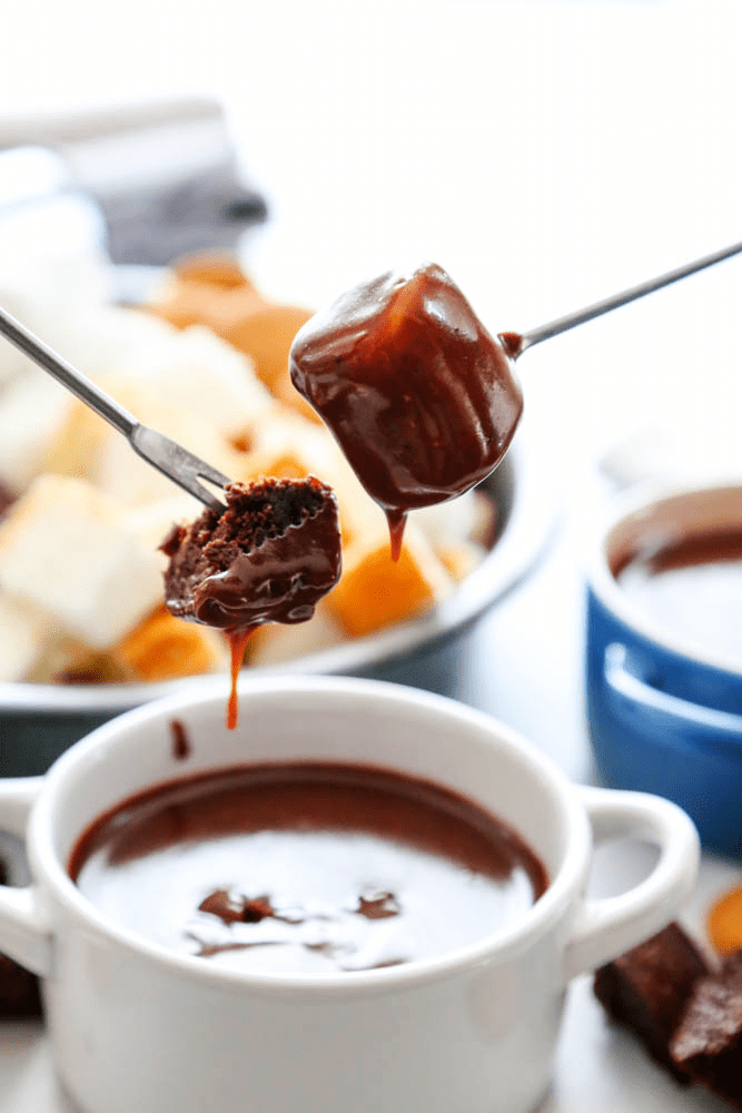 Rich, creamy and decadent this CHOCOLATE PEANUT BUTTER FONDUE recipe is so easy to make and insanely delicious to devour. marshmallow and brownie dipped in fondue