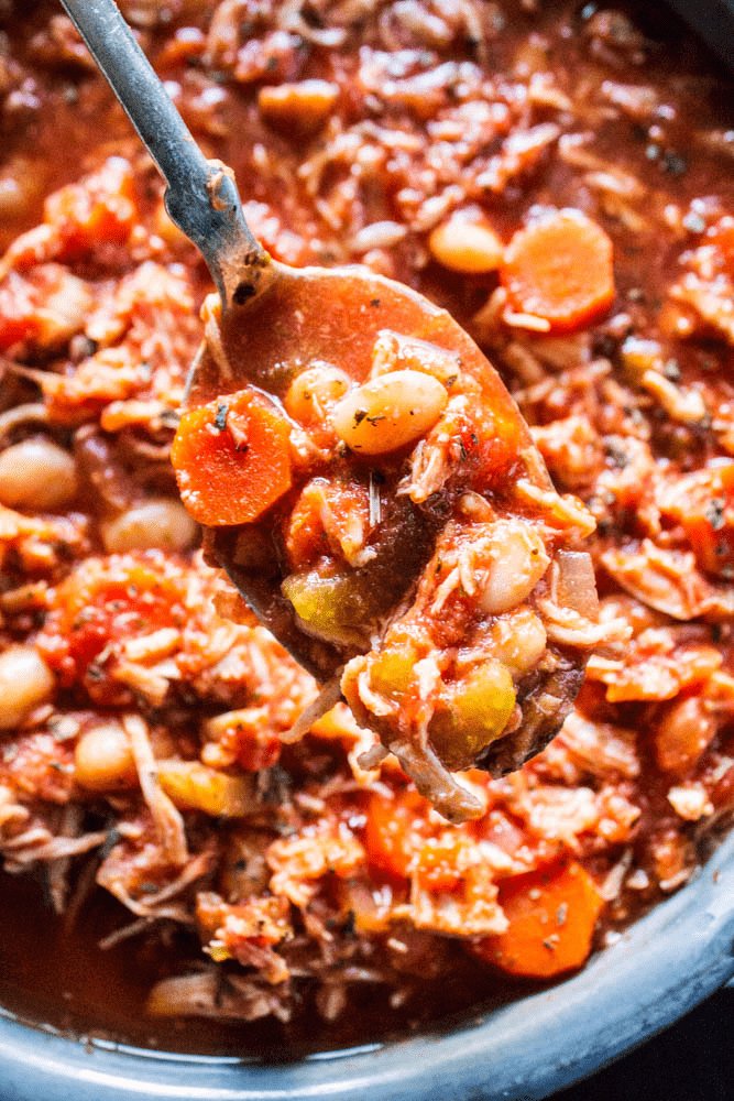 Italian Chicken Stew bite on a spoon over pot of stew