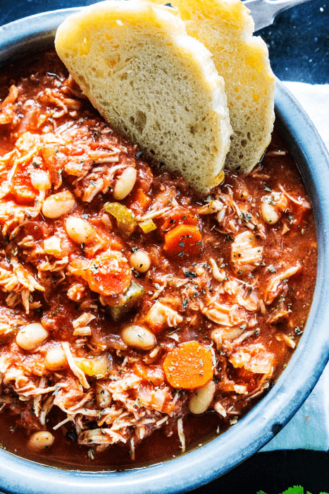 Italian Chicken Stew served in a bowl with 2 slices of italian bread