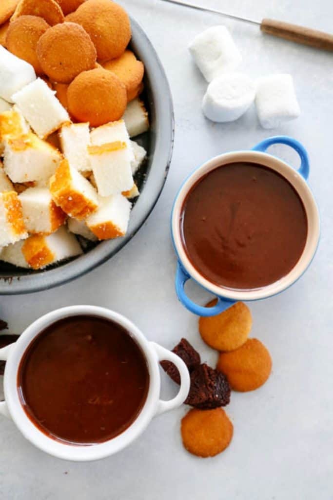 overhead shot of chocolate fondue bowls with shortbread cake
