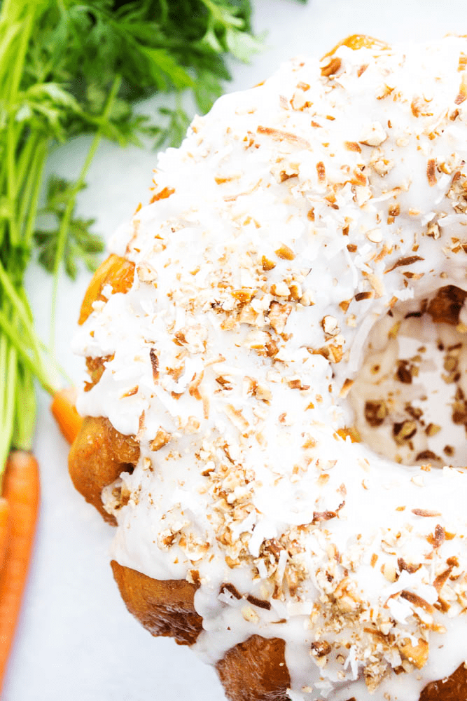 top down photo of carrot cake monkey bread with cream cheese frosting and coconut flakes
